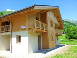 a house with a balcony on the side of it at Appartement de 3 chambres avec jardin et wifi a Hauteluce a 2 km des pistes in Hauteluce