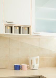 two cups on a counter in a kitchen at Apartments At The Window Of Jerusalem, Jaffa 97 in Jerusalem