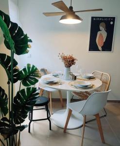 a dining room with a table and chairs and a plant at Douro Valley Terrace Apartments in Armamar