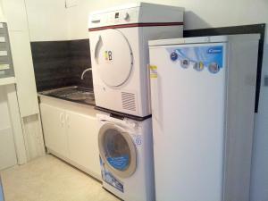 a washing machine and a refrigerator in a kitchen at Appartement de 5 chambres avec jardin et wifi a Hauteluce a 2 km des pistes in Hauteluce