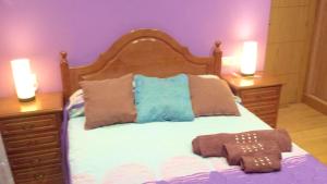 a bedroom with a bed with two night stands and two candles at Elegant House in Pontevedra + Private Pool in Rífrío