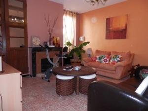 ein Wohnzimmer mit einem Sofa und einem Tisch in der Unterkunft Appartement spacieux avec grand patio, 1er étage in Sigean
