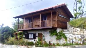 a house with a balcony on top of it at Charming House in Celorico de Basto with Mountain View in Celorico de Basto +13 photos