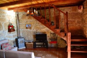 a living room with a staircase in a stone house at Charming House in Celorico de Basto with Mountain View in Celorico de Basto