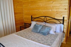 a bed with two pillows on top of it at Charming House in Celorico de Basto with Mountain View in Celorico de Basto