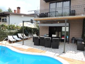 a house with a patio and a swimming pool at Welcoming Villa in Vantačići with Pool and Sea View in Vantačići