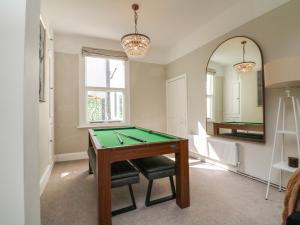 a room with a pool table and a mirror at Myrtle House in Ilfracombe