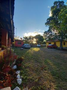 a yard with cars parked in front of a building at Magnificent Private Room Near Airport #1 in Comayagua