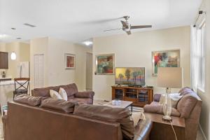 a living room with two couches and a ceiling fan at 4 Bedrooms 3 Bathrooms Crystal Cove 4712 Bd in Orlando