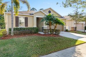 a house with palm trees in front of it at 4 Bedrooms 3 Bathrooms Crystal Cove 4712 Bd in Orlando