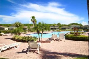 a group of chairs and a swimming pool at 4 Bedrooms 3 Bathrooms Crystal Cove 4712 Bd in Orlando