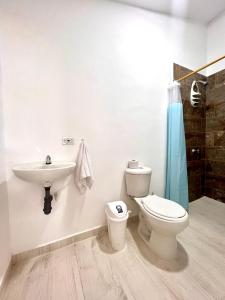 a bathroom with a toilet and a sink at Sereni San Bernardo Hotel Playa in San Bernardo del Viento