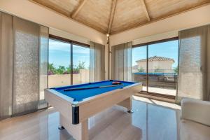 a pool table in a room with windows at VACATION MARBELLA I 300 SQM Penthouse, Private Swimming pool, BBQ, WiFi in Marbella