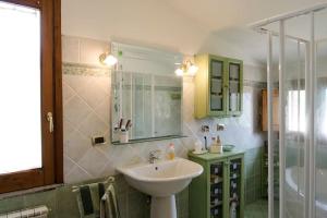 a bathroom with a sink and a shower at Charming House in Decollatura with Jacuzzi in Decollatura +43 photos