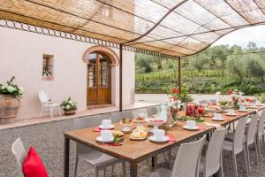 a wooden table and chairs in a patio with a table and chairs at 2 bedrooms appartement with shared pool jacuzzi and wifi at Bottega Genovini in Sorrezzana