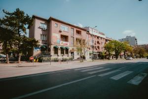 an empty street in a city with buildings at Bloom Suites in Pristina