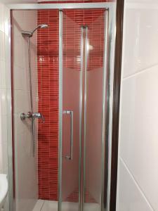 a shower with a glass door in a bathroom at Casa Azul in Albufeira