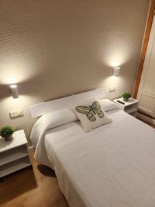 La PueblanuevaにあるHostal Restaurante CASA FRANのベッドルーム(白いベッド、枕付)
