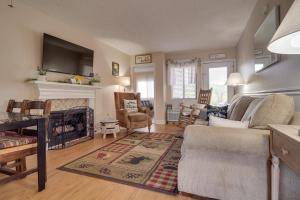 a living room with a couch and a fireplace at Gatlinburg Condo with Mountain Views and Pool Access in Gatlinburg