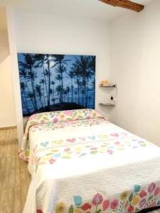 a bedroom with a bed with a painting on the wall at 2 bedrooms house with terrace and wifi at Arnedillo in Arnedillo