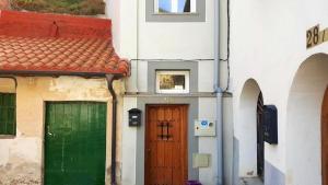 two doors on the side of a building at 2 bedrooms house with terrace and wifi at Arnedillo in Arnedillo
