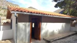 a small house with a brown door in front of it at 2 bedrooms house with terrace and wifi at Arnedillo in Arnedillo