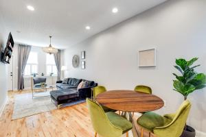 a living room with a table and chairs and a couch at Trendy Fairmount Gem-5 star Location, Roof Deck, PARKING, GR8 for FAMILIES in Philadelphia