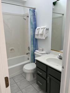 a bathroom with a white toilet and a sink at Bryce Pioneer Village in Tropic