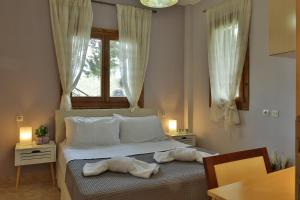 a bedroom with a bed with two towels on it at ZeusPlace Olympus Olive Country House 4 in Leptokaria