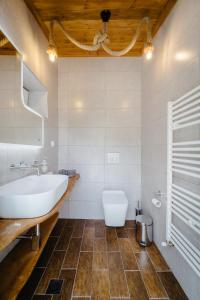 a bathroom with a tub and a toilet and a sink at Kritamos Luxury Apartment in Chrysi Ammoudia