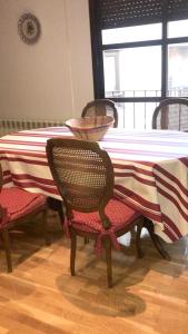 a dining room table with a red and white table cloth at 2 bedrooms apartement with city view balcony and wifi at Ciudad Real in Ciudad Real