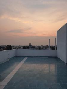 a rooftop with a view of the city at sunset at Auro Maison in Puducherry