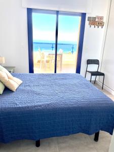 a bedroom with a bed and a view of the ocean at Mojacar Espectaculares Vistas al Mar in Mojácar