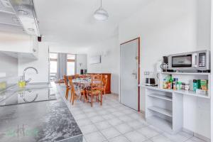 a kitchen and dining room with a table with chairs at GITE Didine in Montmin