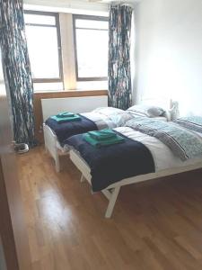 a bedroom with a bed with two towels on it at Trendy, urban open plan apartment (City centre) in Bristol