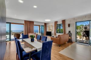 a living room with a table and chairs and a couch at Villa Rita in Makarska