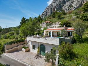 an aerial view of a house with a mountain in the background at Villa Rita in Makarska
