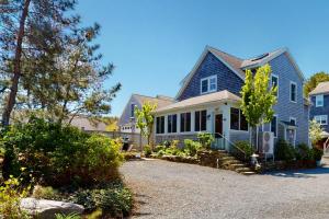 a blue house with a gravel driveway at Beech Tree Retreat in Provincetown