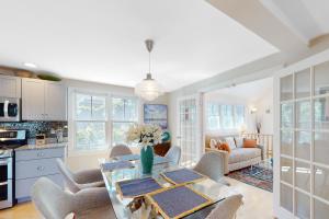 a kitchen and living room with a table and chairs at Beech Tree Retreat in Provincetown