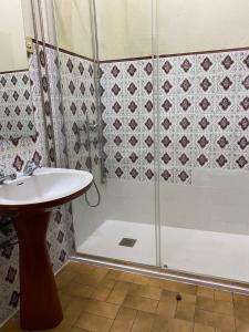 a bathroom with a shower and a sink at Hospedaria Porto in Porto