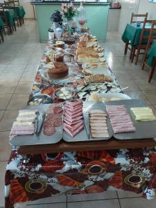 a long table filled with different types of food at Pousada Cabana in Avaré