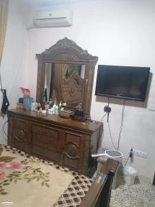 a room with a wooden dresser with a mirror at Duraidi in Amman