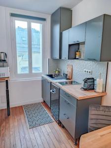 a kitchen with a counter and a sink and a window at The blue suite Etretat in Étretat