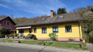 a yellow house on the side of the road at Leimbach in Bad Brückenau