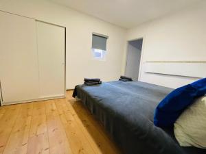 a bedroom with a large bed and a wooden floor at Red app by Alex Rafel, close to the bus station in Zagreb