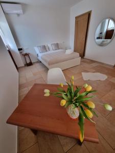 a living room with a table and a bedroom at Villa Sweery in Santa Maria a Vico