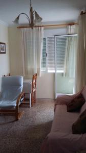 a living room with a table and a couch and a window at 2 bedrooms apartement with sea view shared pool and furnished balcony at Aguilas in Águilas