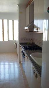 a kitchen with a sink and a counter top at 2 bedrooms apartement with sea view shared pool and furnished balcony at Aguilas in Águilas