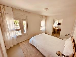 a bedroom with a white bed and a window at Live it up Marvila in Lisbon