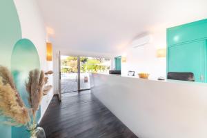 a kitchen with a white counter and blue cabinets at Les Capucines Saint Tropez in Saint-Tropez